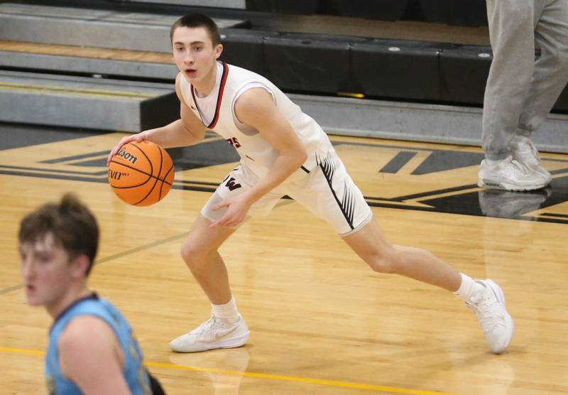Woodland's Grant Wissen looks to pass the ball off against Marquette during the Tri-County Conference Tournament championship game on Friday, Jan. 30, 2026 at Putnam County High School.