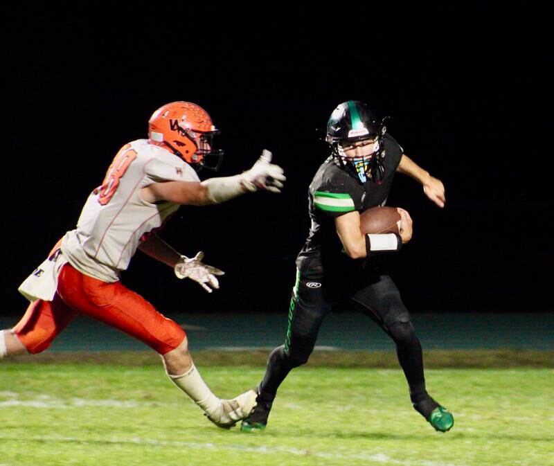 Rock Falls' Kohle Bradley (11) eludes a Winnebago tackler on Friday.