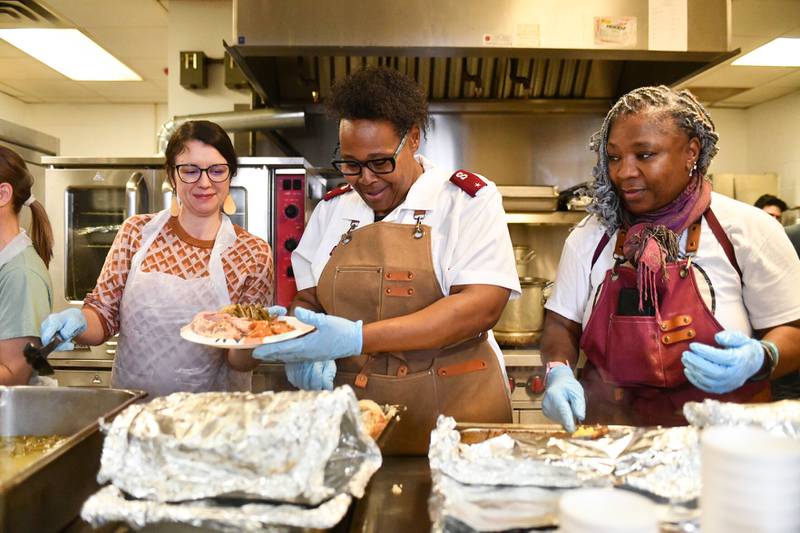 Kankakee Salvation Army Lt. LaToya Surratt, center, helps plate food with volunteers Lana Arndt, left, and Mary Taylor on Wednesday during the organization's annual Thanksgiving meal.
