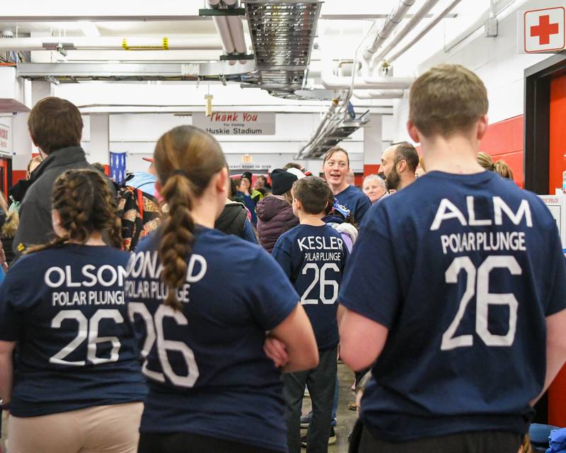 Hiawatha Students and teachers wear shirts with their name and Polar Plunge 26 on the back of them for the Saturday Feb. 21, 2026, Polar Plunge event held at Huskie Stadium in DeKalb.