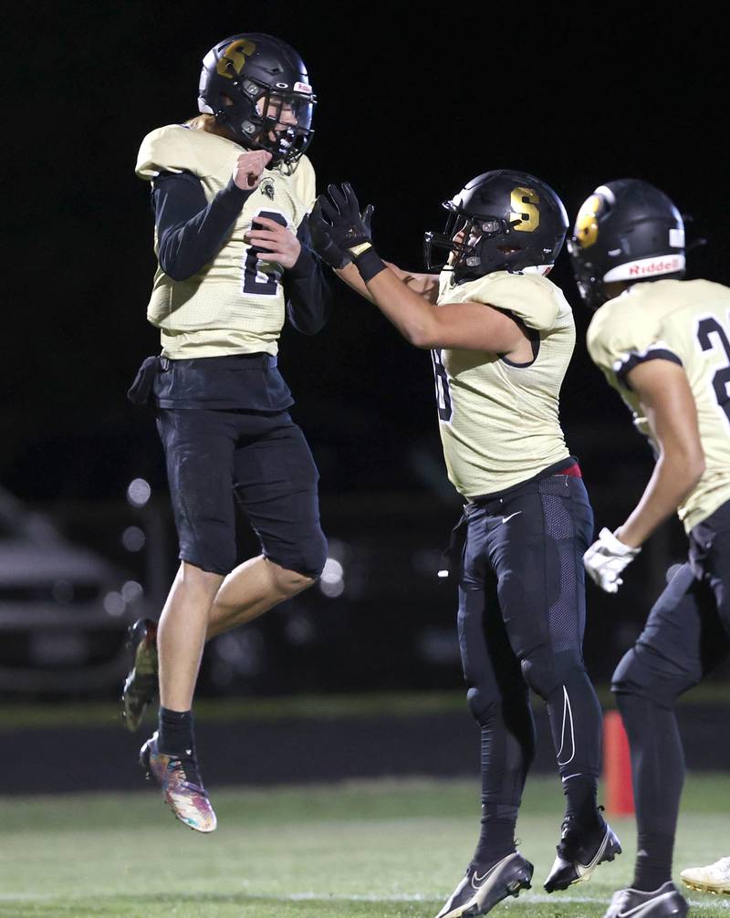 Sycamore's Elijah Meier (left) celebrates with Diego Garcia after Garcia retuned a blocked punt for a touchdown during their game against Woodstock North Friday Oct. 7, 2022, at Sycamore High School.