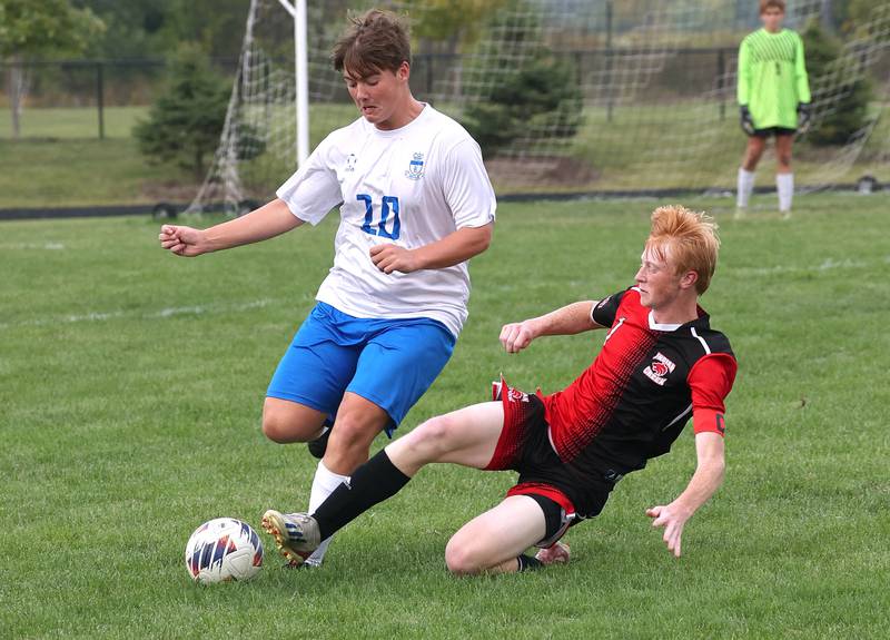 Indian Creek's Tyler Bogle tries to get the ball from Hinckley-Big Rock's Austin Roop with a slide tackle during their game Wednesday, Sept. 20, 2023, at Pack Park in Waterman.