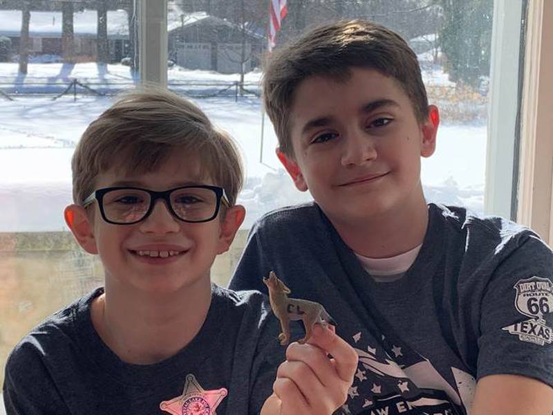 John Niziolek, 10, and Evan Niziolek, 9, are photographed with the toy coyote on Jan. 26, 2021.