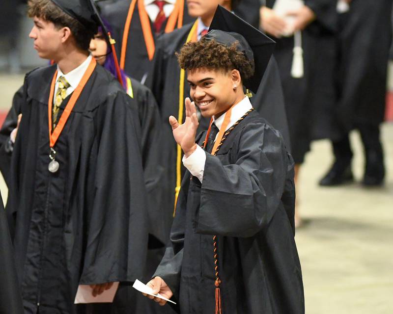 A St. Charles East graduate waves during the commencement ceremony on Monday, May 18, 2026, held at the Convocation Center in DeKalb.