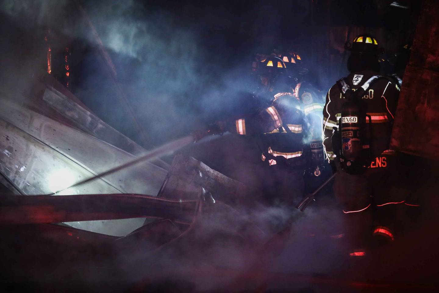 Firefighters battle a blaze at a barn near Harvard on June 9, 2025, that killed six horses.