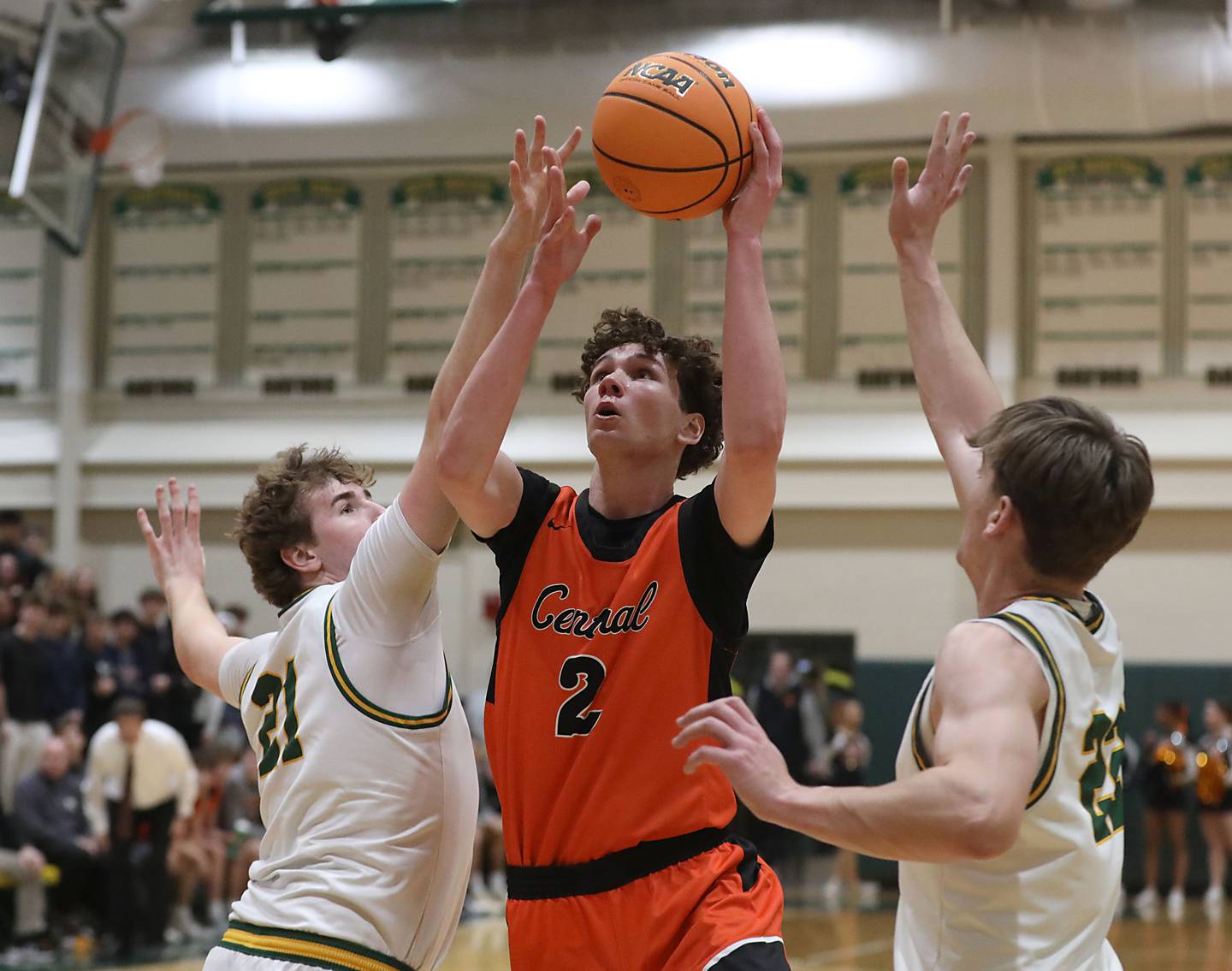 Crystal Lake Central's Danny Spychala drives to the basket between Crystal Lake South's Ryan Morgan (left) and Nick Stowasser (right)during an IHSA Class 3A Crystal Lake South Regional boys basketball semifinal game on Wednesday, February, 25, 2026, at Crystal Lake South High School.