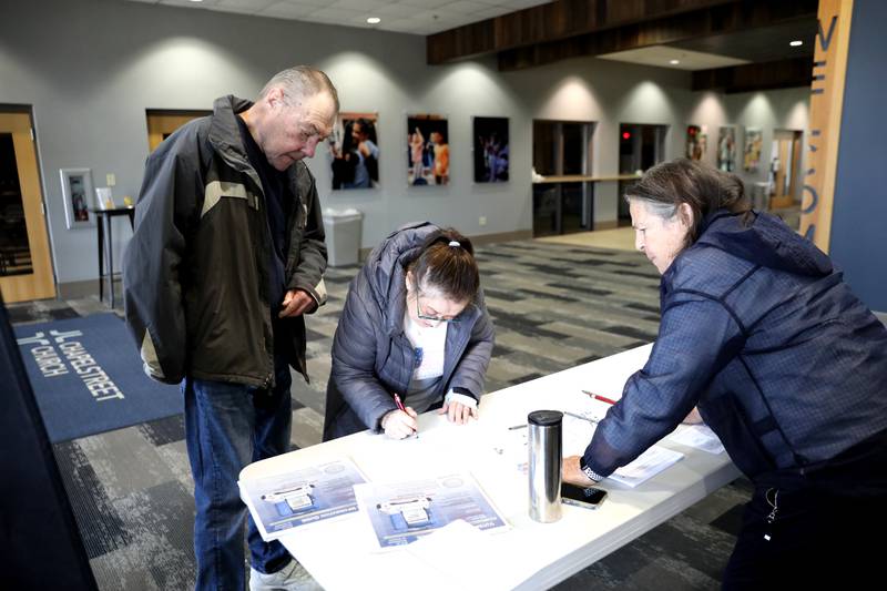 Jim and Laura Webb of Geneva fill out their paperwork as election judge Ellen Jo Ljung looks on as they prepare to vote in the 2025 Consolidated Election on Tuesday, April 1, 2025 at Chapelstreet Church in Geneva.
