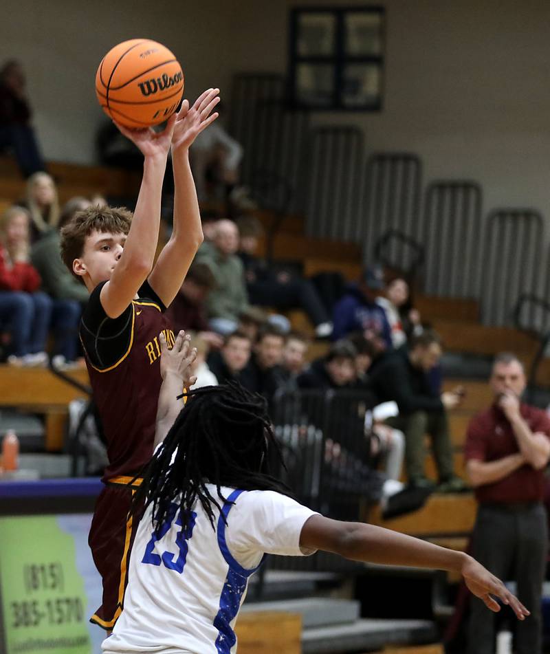 Richmond-Burton's William Gardner shoots th ball over Woodstock's Marc Thomas during a Kishwaukee River Conference boys basketball game on Wednesday, February. 4, 2026, at Woodstock High School.
