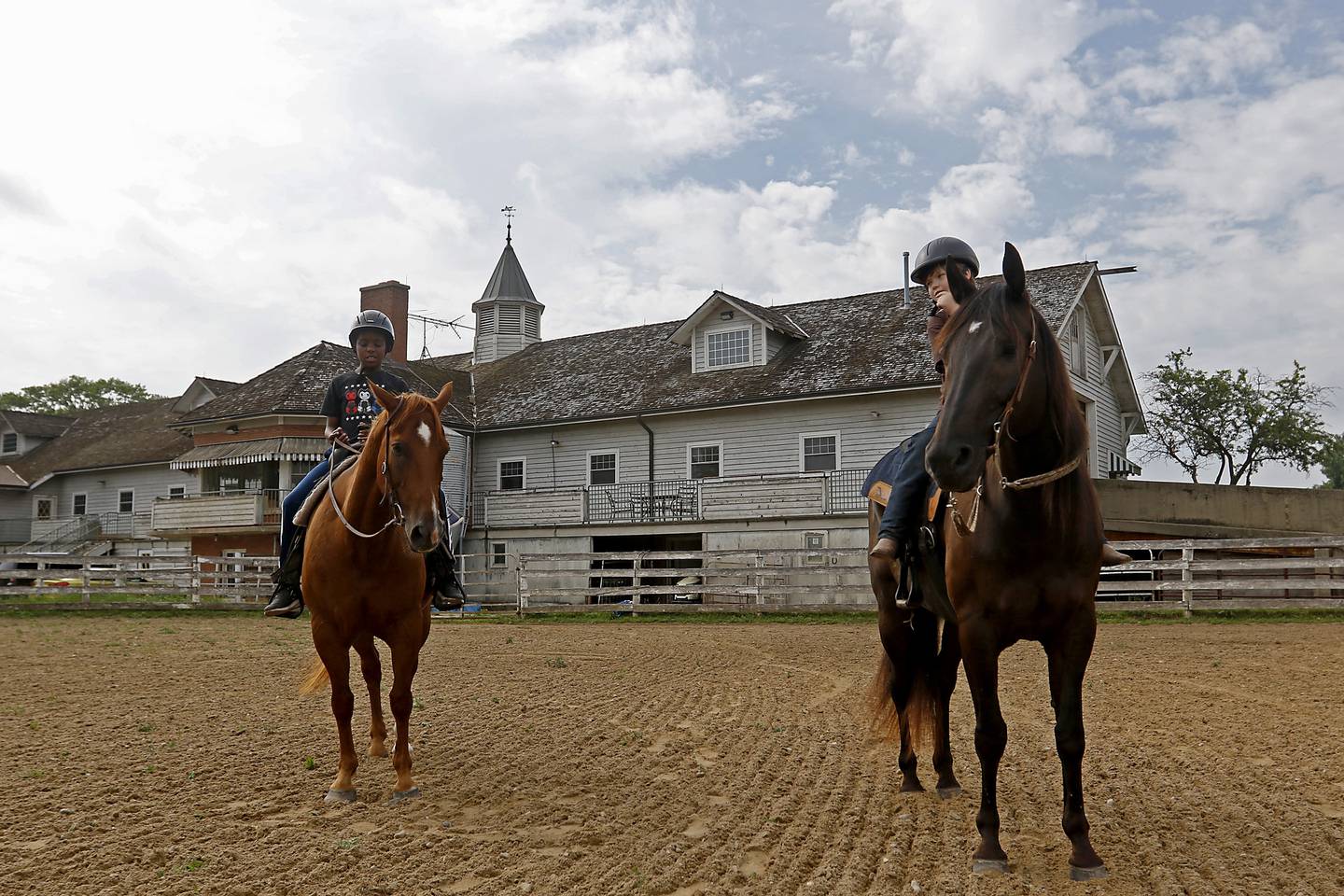 Richard Taylor-Terry, 11, and Joseph Birong, 6, ride Danta and Hunter, both retired Medieval Times horses, Friday July, 8, 2022, at the R Double J Ranch, 2800 Derby Lane, in McHenry. The R Double J Ranch recently got the contract to operate this equine facility from McHenry with the goal of making it more of a community-centric center and make learning about horses and riding open to all.