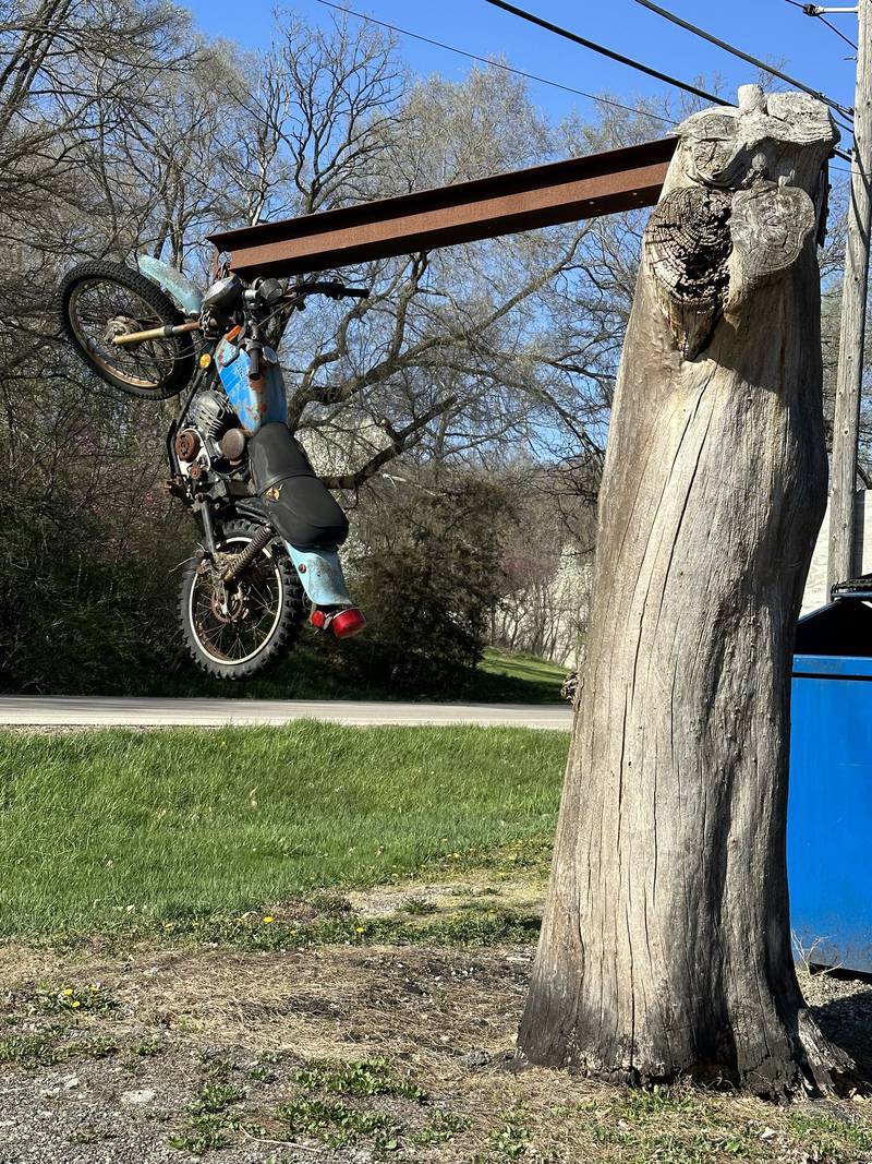This motorcycle is hanging off of a tree in front of Fat Daddy's Bar and Grill on Thursday, April 13, 2023 along U.S. Route 6 in Seneca.