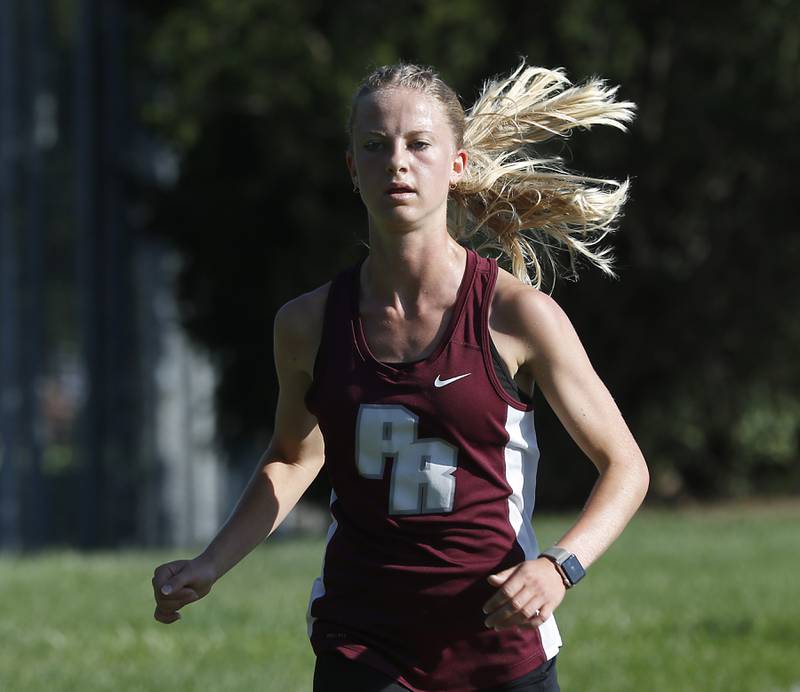 Prairie Ridge’s Rachel Soukup leads the girls race of the McHenry County Cross Country Meet Saturday, August 27, 2022, at Emricson Park in Woodstock.