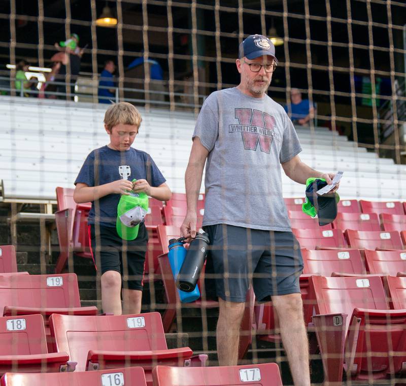 Sean King for the Daily Herald
Dan Pagni and his son Marcus Pagni 9, of Mundelein walk to their seats prior to the start of the Kane County Cougars opening day baseball game at Northwestern Medicine Field in Geneva on Friday, May 13, 2022.