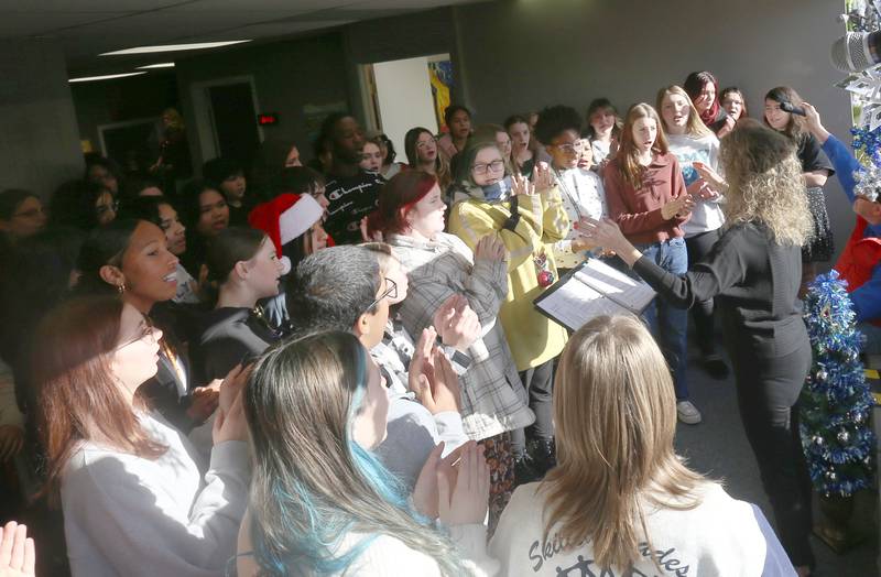 Students from Shepard Middle School sing Christmas songs during the annual Freezin' for a Reezin' event on Friday, Dec. 6, at WCMY in Ottawa. The all-day event to helps the Ottawa Community Food Basket.