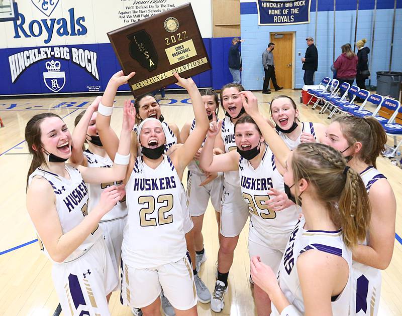 Members of the Serena girls basketball team hoist the Class 1A Sectional plaque after defeating Newark in the Class 1A Sectional final game on Thursday, Feb. 24, 2022, in Hinckley.