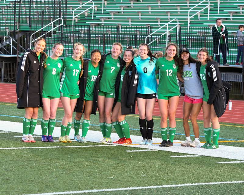 The York High School girls’ soccer team are all smiles as they pose for a photo after defeating Downers Grove South in the regional title game on Friday May 23, 2025, held at York High School.