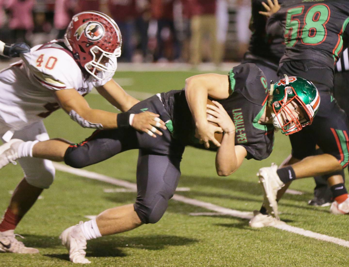 L-P's Matt Carrico (no,5) runs the ball as he is brought down by Morris's Jorge Loza on Friday Oct. 15, 2021.