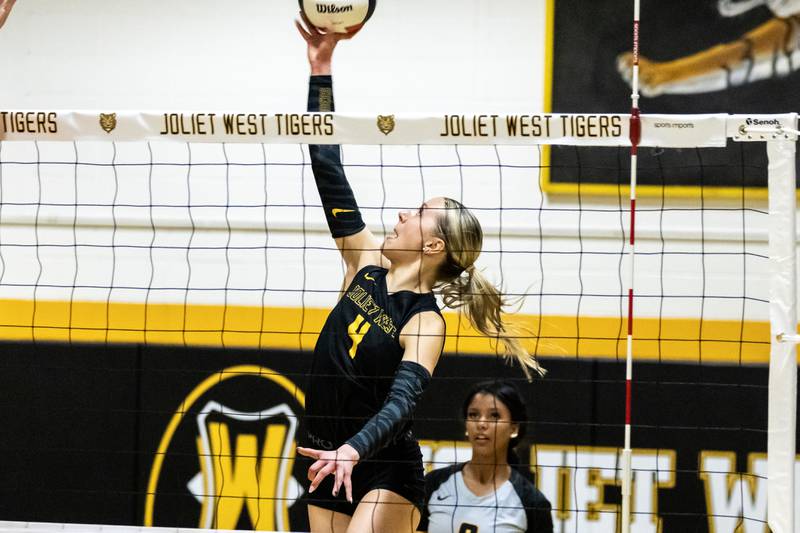 Joliet West's Lina Govoni taps the ball over the net during a 4A sectional varsity volleyball game against Oswego at Joliet West on Nov. 4, 2025.