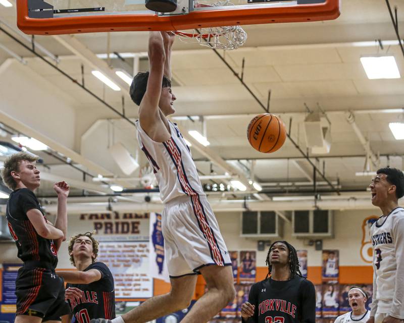 Oswego's Niko Jurkovic (14) dunks during their basketball game between Yorkville at Oswego, Feb 7, 2026 in Oswego.