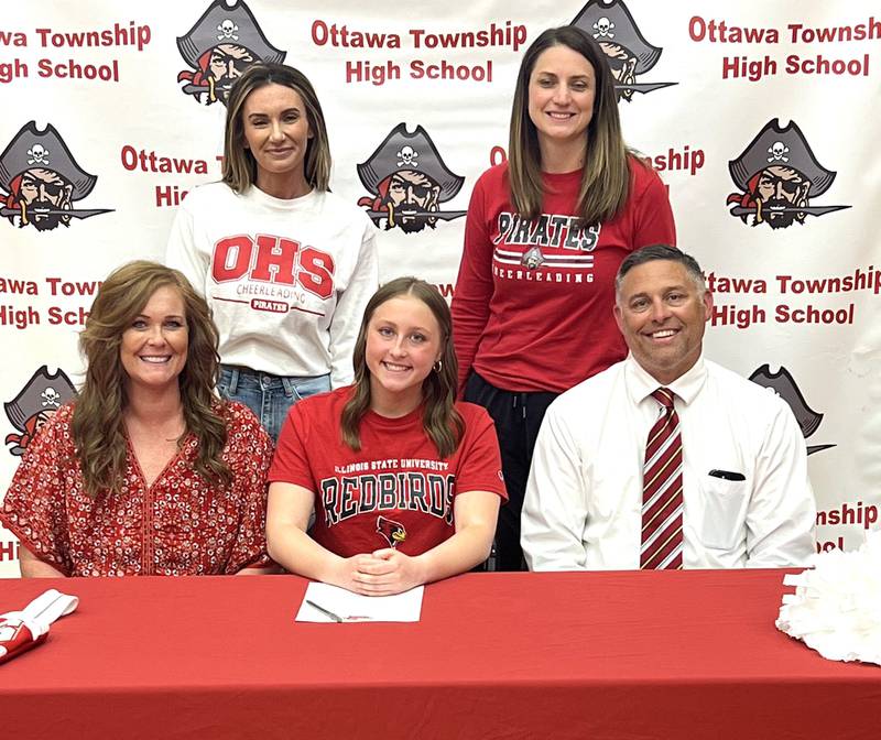 Ottawa’s Cabella DeBernardi has signed to continue her education at Illinois State University in Normal and her cheer career with the Redbirds. She is pictured here at her signing ceremony alongside her parents with her cheer coaches standing behind.
