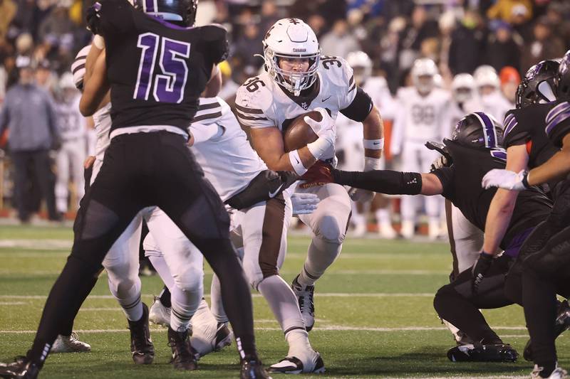 Mt. Carmel’s Parker Startz finds a hole to run through against Downers Grove North in the Class 7A championship on Saturday, Nov. 25, 2023 at Hancock Stadium in Normal.