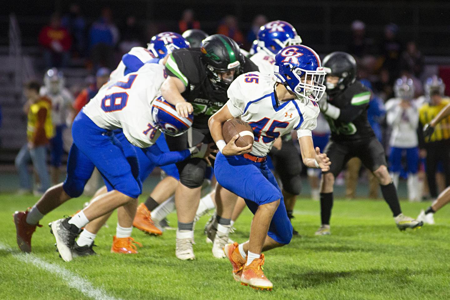 Genoa-Kingston’s Maddox Lavender picks up yards Friday, Sept. 23, 2022 against Rock Falls.