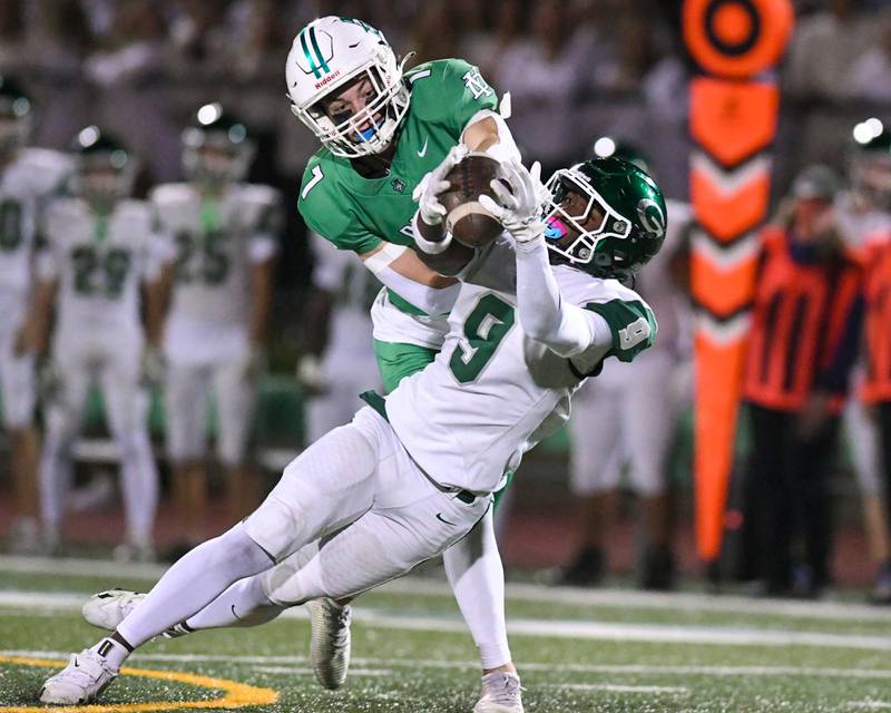 Glenbard West's Jaylen McMiller (9) catches the ball for a first down during the game while being defended by York's Drew Richardson (7) on Friday Oct. 17, 2025, held at York High School.