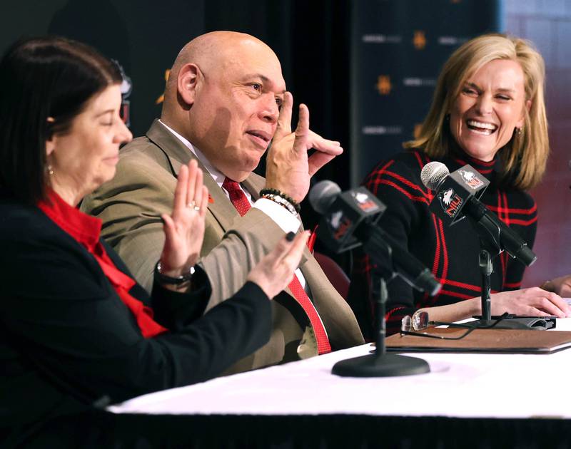 Northern Illinois University Vice President and Director of Athletics, and Recreation, Sean Frazier, does the Huskies sign for Horizon League Commissioner Julie Roe Lach during a press conference Thursday, Feb. 27, 2025, at the Convocation Center announcing that NIU will be joining the Horizon League starting with the fall 2026 season for most sports other than football.