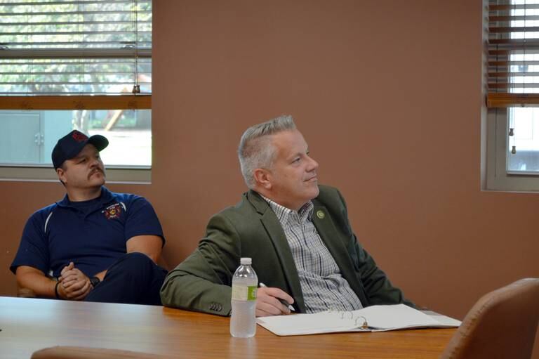 U.S. Rep. Eric Sorensen, D-Rockford (right), and Sterling Fire Department Capt. Clark Liedberg (left) listen on Friday, Aug. 9, 2024, in the Rock Falls Fire Department as Rock Falls Deputy Fire Chief Kyle Sommers talks about the training center the two fire departments plan to build. Sorensen is requesting $1.5 million in federal funding to go toward the project.