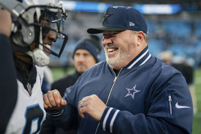 Dallas Cowboys head coach Mike McCarthy talks with Carolina Panthers cornerback Jaycee Horn (8) after an NFL football game between the Carolina Panthers and the Dallas Cowboys on Sunday, Dec. 15, 2024, in Charlotte, N.C. (AP Photo/Jacob Kupferman)