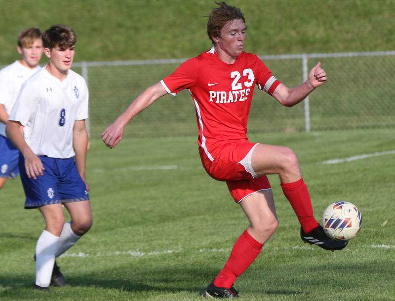 Ottawa's Evan Snook kicks the ball away from Princeton's Chase Sims on Tuesday, Oct. 3, 2023 at Ottawa High School.