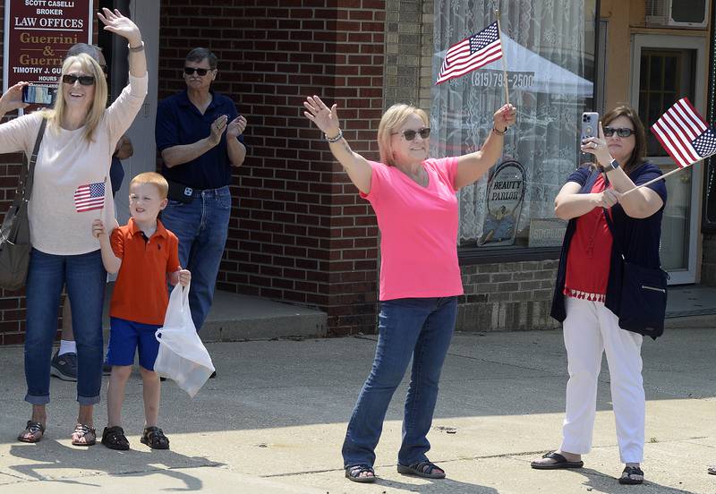 Locals wave to the riders Saturday, June 17, 2023, as they enter Marseilles during the annual the Illinois Motorcycle Freedom Run.