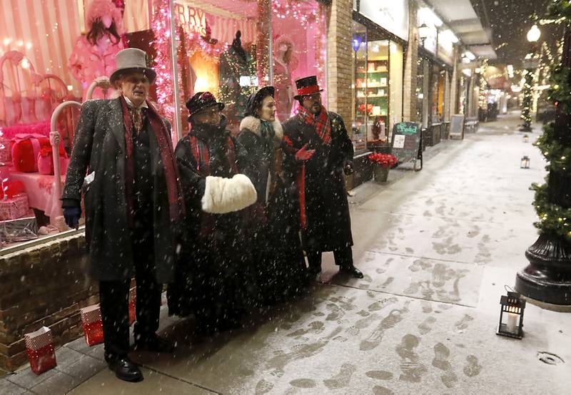 The Frozen Robins sing during Crystal Lake's Luminary Nights on Thursday, Dec. 19, 2024, in downtown Crystal Lake. The snowy night featured sidewalks lite luminaries, holiday shopping and a visit to the Santa House.