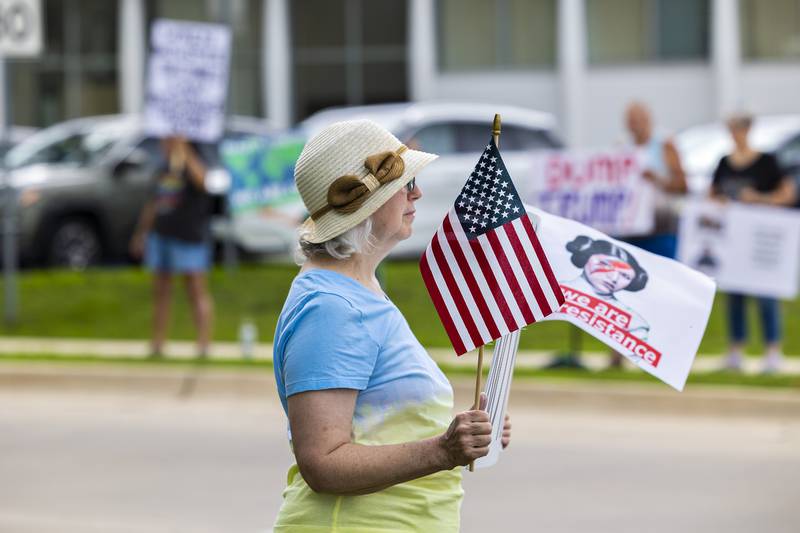 Anne Hilliard of Dixon protests Thursday, July 17, 2025, in Sterling. The protest, slugged “Good Trouble Lives On,” is a national day of peaceful protest marking the fifth anniversary of the death of U.S. Rep. John Lewis, a civil‑rights icon.