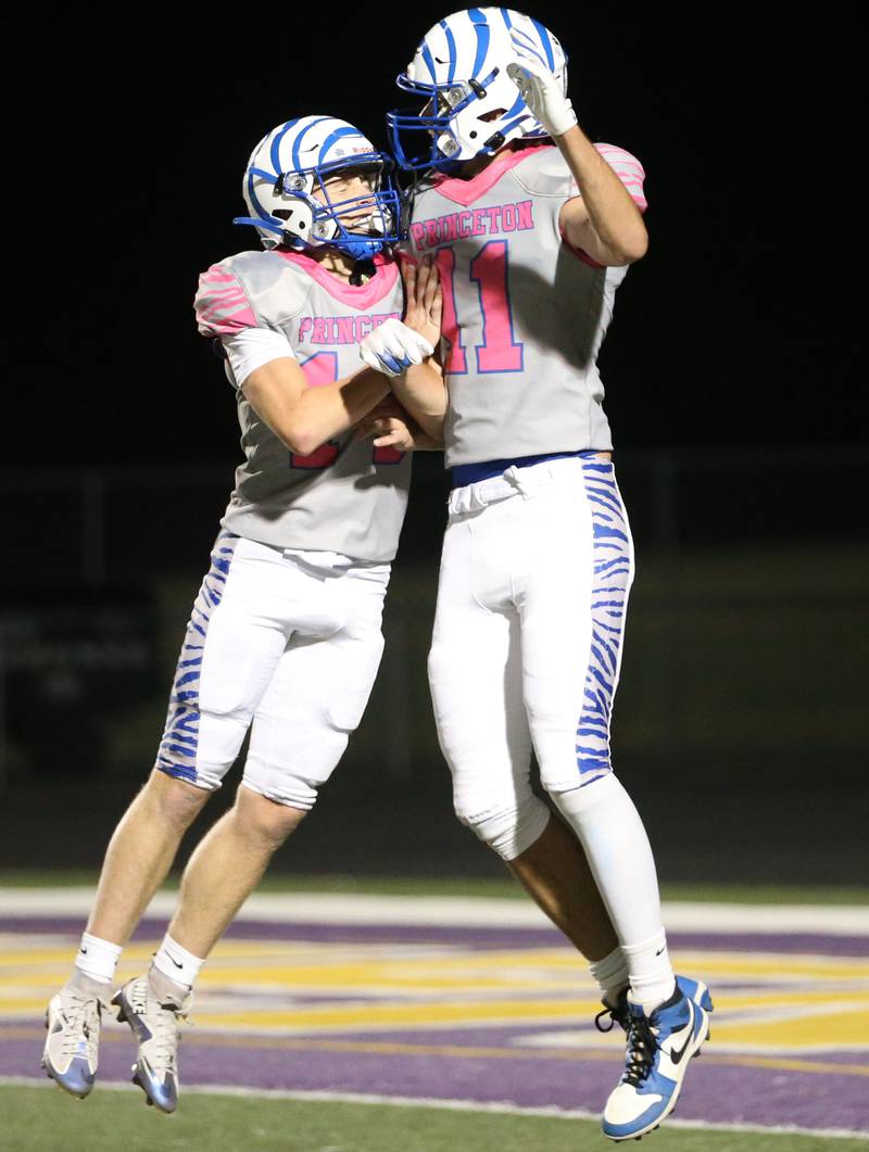 Princeton's William Lott and Noah LaPorte leap in the air after scoring a touchdown against Mendota on Friday, Oct. 11, 2024 at Mendota High School.