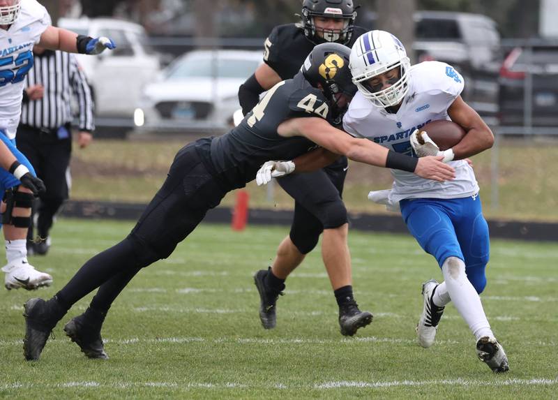 St. Francis' Jalen Carter is tackled by Sycamore's Cooper Bode Saturday, Nov. 16, 2024, during their Class 5A quarterfinal game at Sycamore High School.