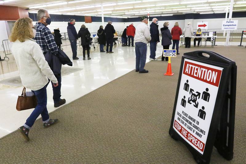 In this Shaw Media file photo, people line up on Tuesday, March 2, 2021, to check in for their appointments at a McHenry County Department of Health COVID-19 vaccination clinic at the site of a former Kmart, 1900 N. Richmond Road, McHenry.