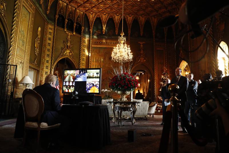 FILE - Then-President Donald Trump listens during a Christmas Eve video teleconference with members of the military at his Mar-a-Lago estate in Palm Beach, Fla., Dec. 24, 2019. Trump says the FBI is conducting a search of his Mar-a-Lago estate. Spokespeople for the FBI and the Justice Department did not return messages seeking comment Monday, Aug. 8, 2022.(AP Photo/Andrew Harnik)