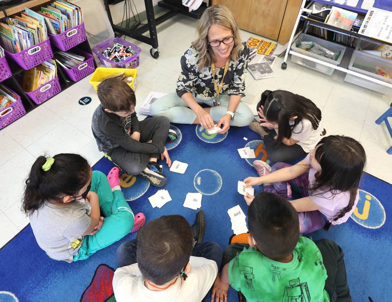 Tracy Paszotta, a kindergarten teacher at Littlejohn Elementary School, works through a lesson with students during small group time in class Monday, March 28, 2022, at the school in DeKalb.