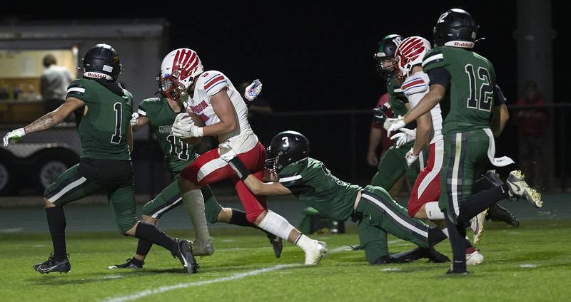 Oregon’s Hunter Bartel is tackled is finally hauled down by the Rock Falls defense after picking up big yards Friday, October 11, 2024, in Rock Falls.