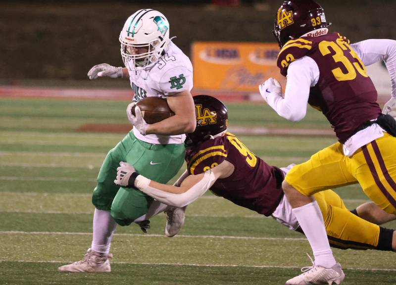York’s Jimmy Conners is brought down by Loyola Academy's Gavin King during their Class 8A state championship game Saturday, Nov. 30, 2024, in Hancock Stadium at Illinois State University in Normal.
