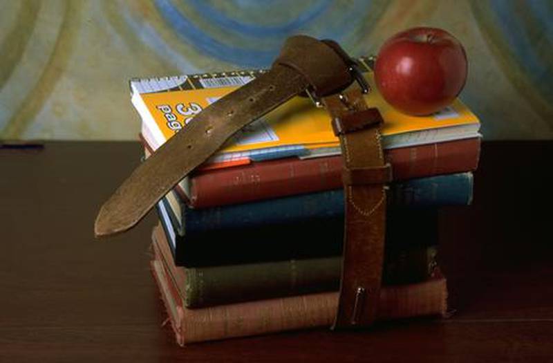 A generic photo of schoolbooks and an apple.