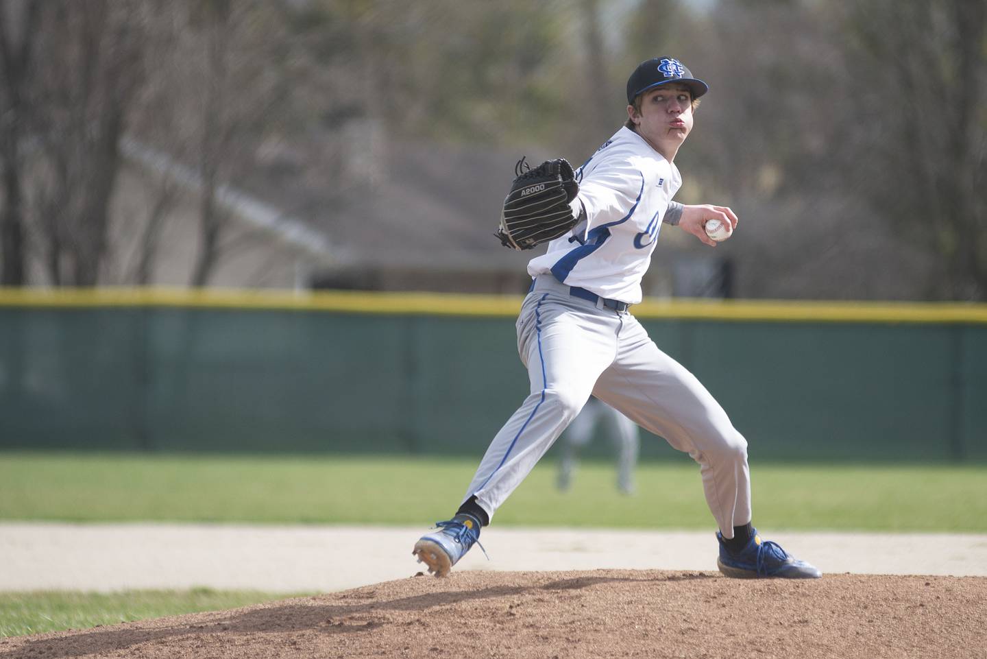 Newman's Brendon Tunink fires a pitch against St. Bede Thursday, April 14, 2022.