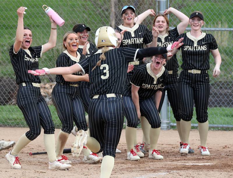 Sycamore's Faith Heil heads to meet her teammates at the plate after homering Tuesday, April 22, 2025, during their game against Kaneland at Sycamore High School.