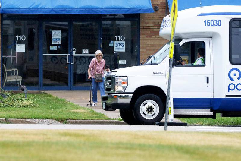A woman heads to the PACE bus in July 2018 after visiting Senior Services Associates Inc. in Crystal Lake.