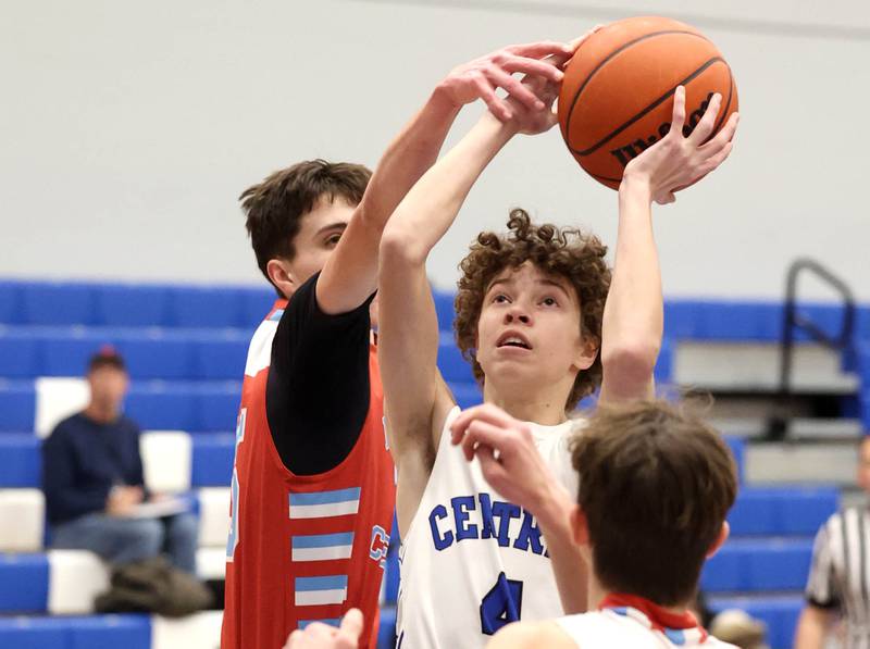 Burlington Central's Ryan Carpenter gets between two Marian Central defenders Monday, Jan. 15, 2023, during their game in the Burlington Central Martin Luther King Jr. boys basketball tournament.