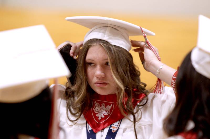 Benet graduate Annie Eschenbach adjusts her cap before the school’s commencement ceremony at the Lisle school on Thursday, May 25, 2023.