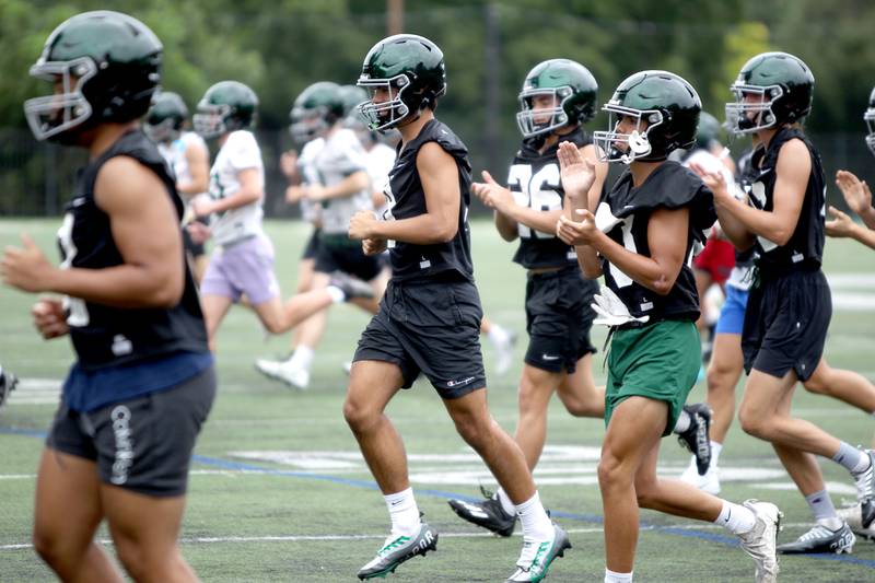 Glenbard West players run drills during the first official day of practice in Glen Ellyn on Monday, Aug. 8, 2022.