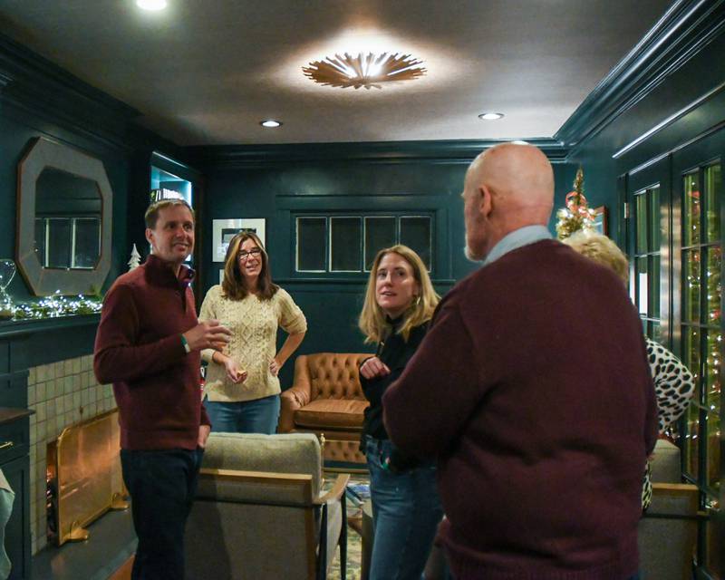 Beth Augustine of the Augustine Home talks about the sitting room with community members during the Holiday Sip and Sweet Tour in La Grange on Sunday Dec. 17, 2023.