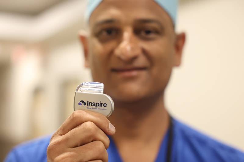 Dr. Rajeev Mehta holds up the Inspire device that is implanted to help with sleep apnea at Silver Cross Hospital. Wednesday, June 28, 2022 in New Lenox.