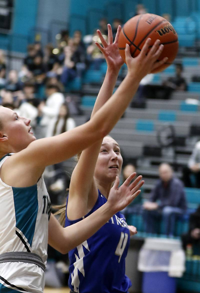 Woodstock's Lily Novelle rushes to block the shot of Woodstock North’s Caylin Stevens during a Kishwaukee River Conference girls basketball game on Friday, Jan. 5. 2024, at Woodstock North High School.